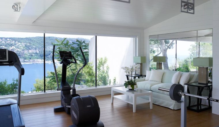 Home gym overlooking the sea by Thorpe Design